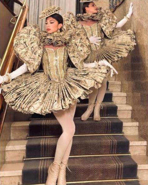 Performers in gold ruffled dresses