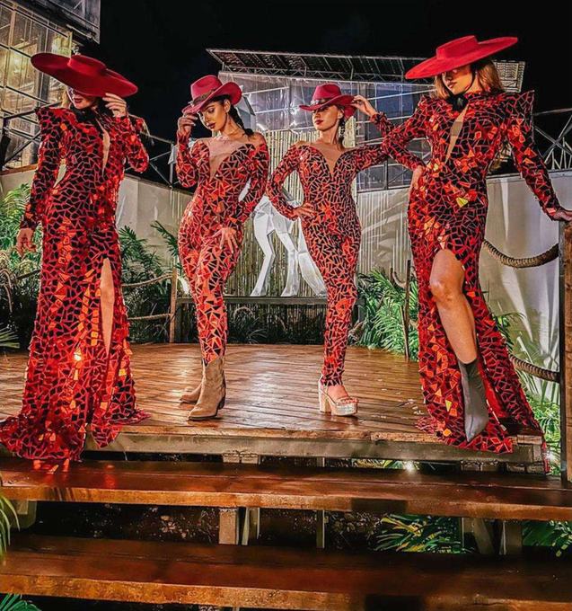 Four performers in red