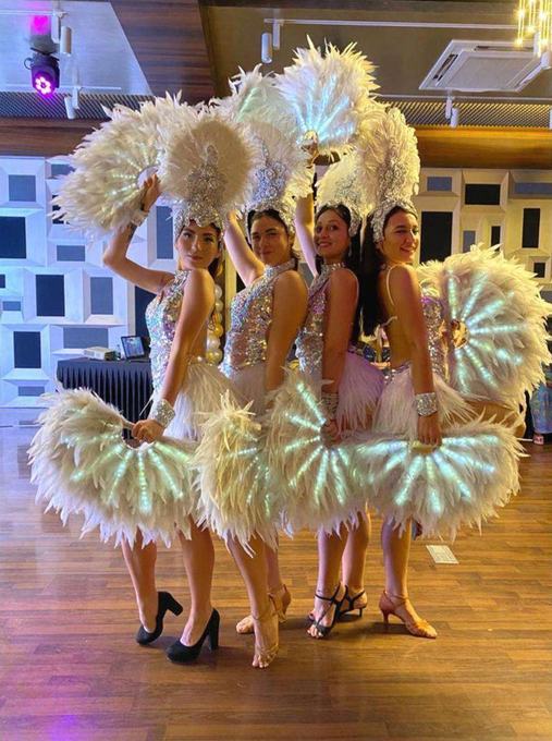 Performers in feathered headdresses