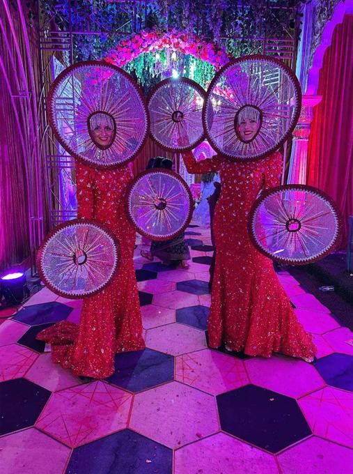 Performers in red sequined dresses