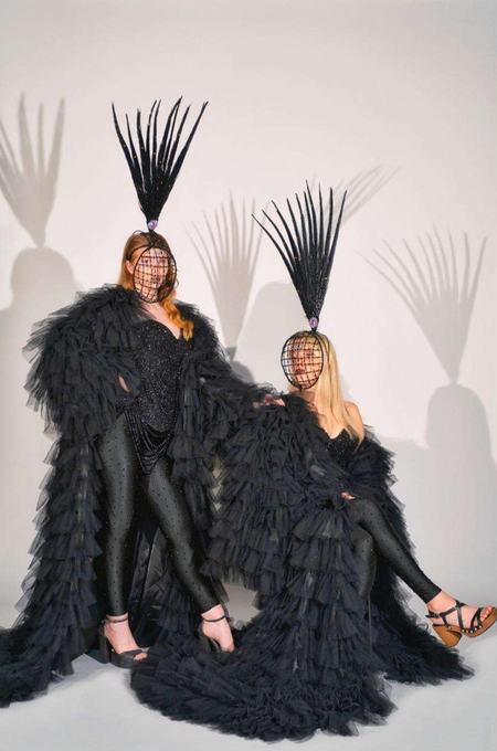 Performers in black headdresses