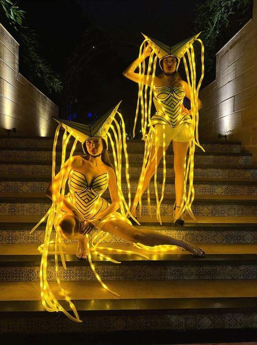 Performer on golden lit stairs