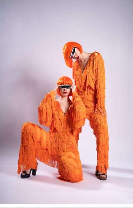 Performers in vivid orange