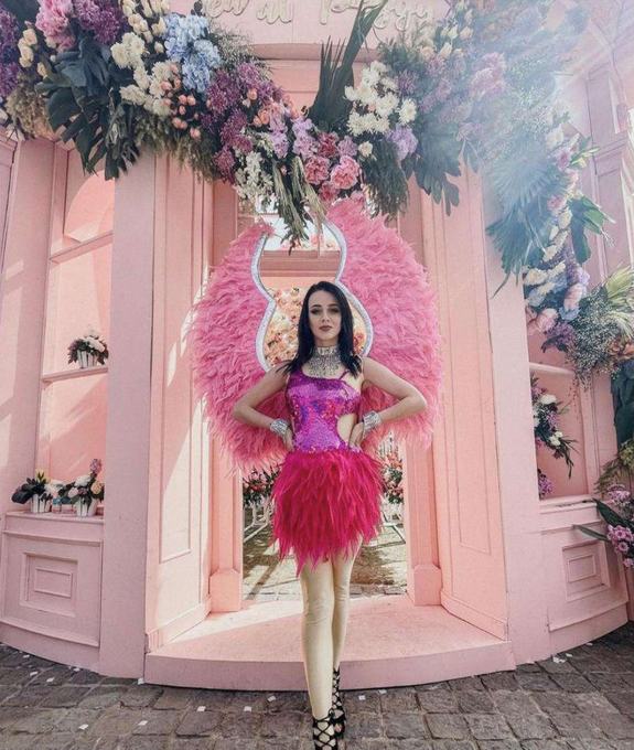 Performer in a pink winged costume