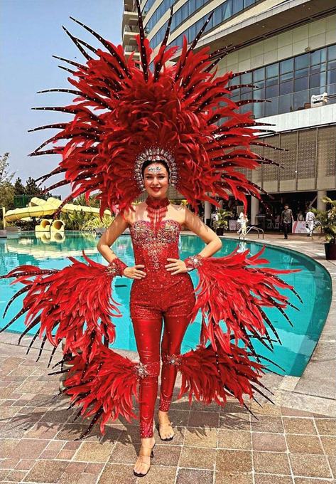 Performer in a red feathered costume