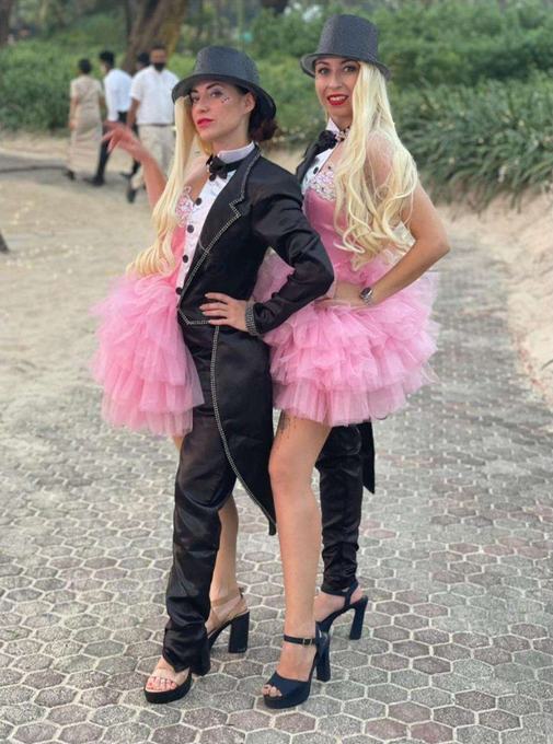 Performers in pink ruffled dresses