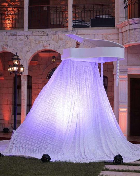 Suspended white piano performance