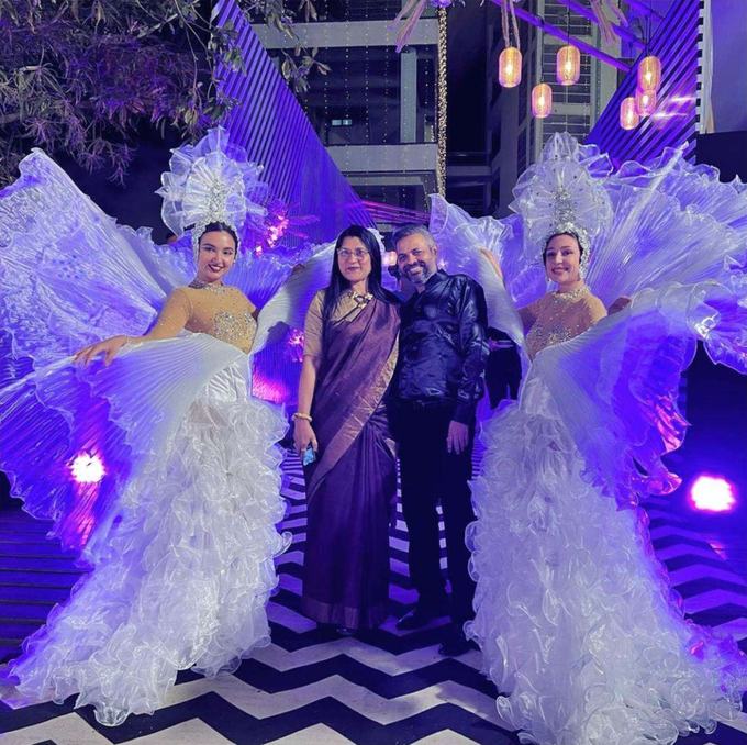 Couple flanked by winged performers