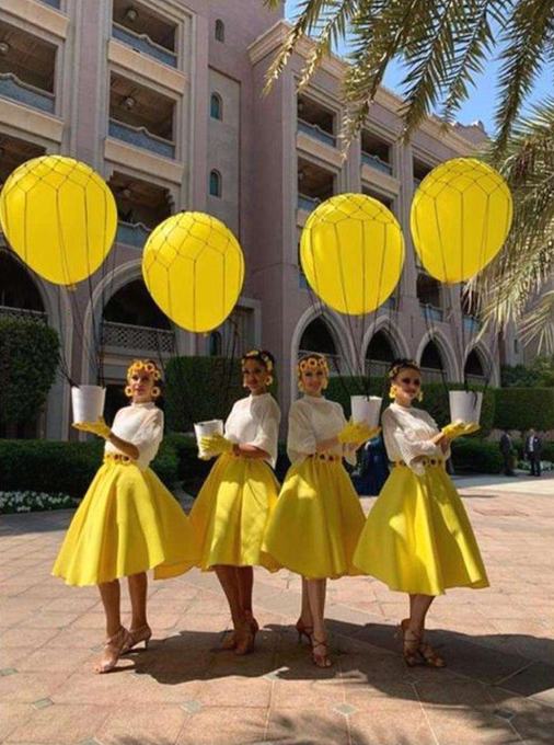 Entry performers with yellow balloons